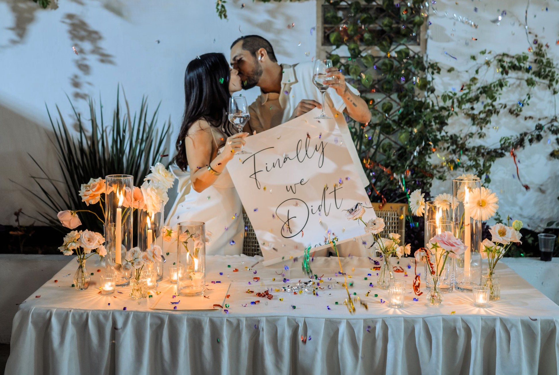 Happy couple celebrating engagement with 'Finally we said yes' sign