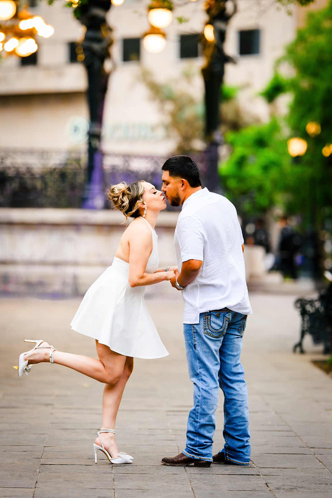 Couple under illuminated gazebo at golden hour